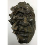 A 20th Century pottery face mask sculpture with relief work block type cubist style decoration and