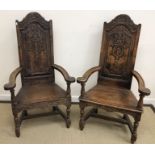 A pair of oak Wainscott type chairs, the backs with scrolling and hare bell decoration,