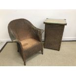 A Lloyd Loom conservatory tub chair and matching single door cupboard,