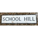 A painted metal street sign inscribed "School Hill" 91.