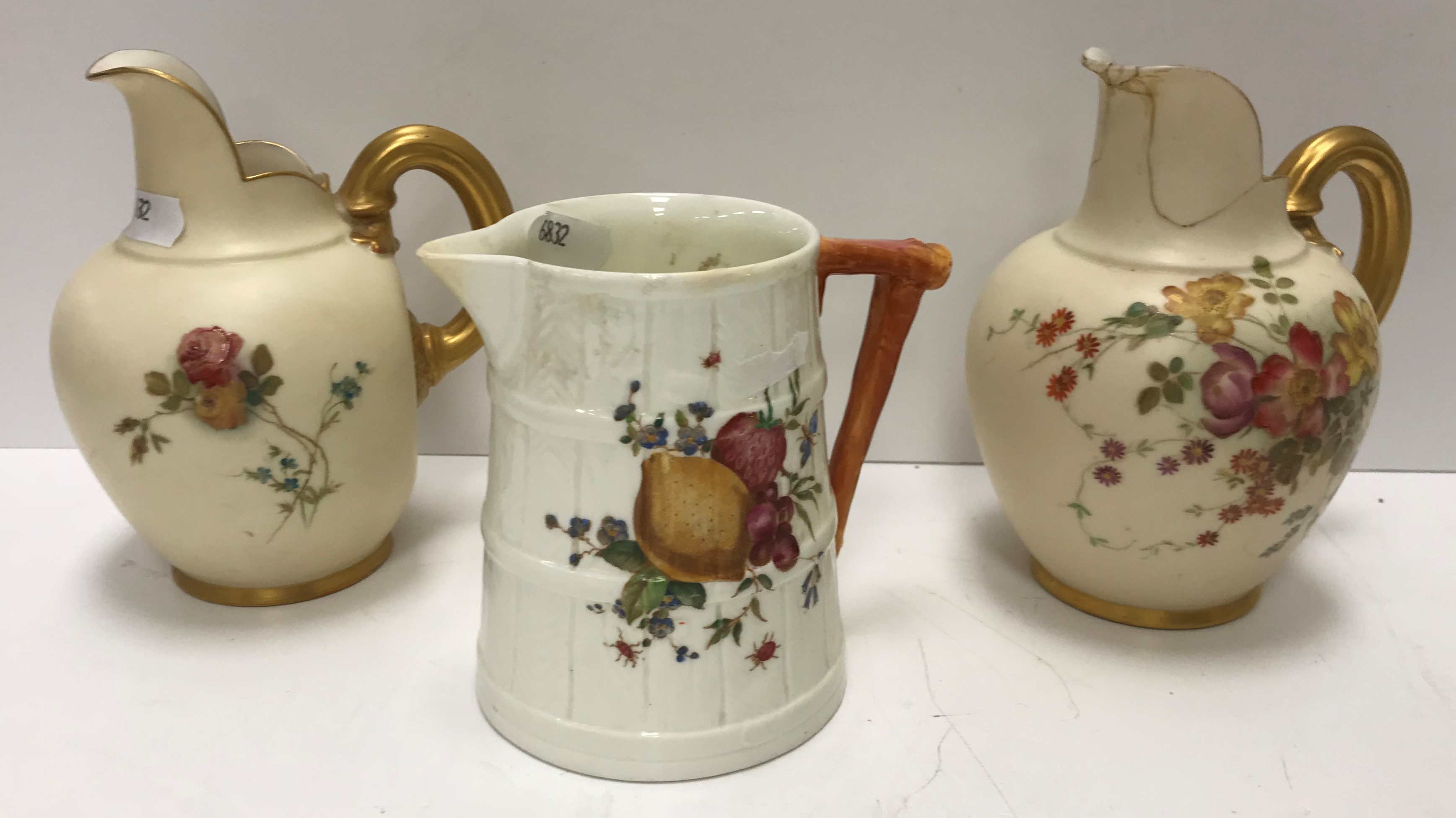 A Royal Worcester etruscan style cream jug with floral spray decoration and gilt handle date marked