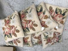 A set of eight needlework floral decorated cushions,