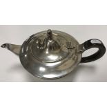 A George V silver teapot of plain form, the lid with silver acorn finial,