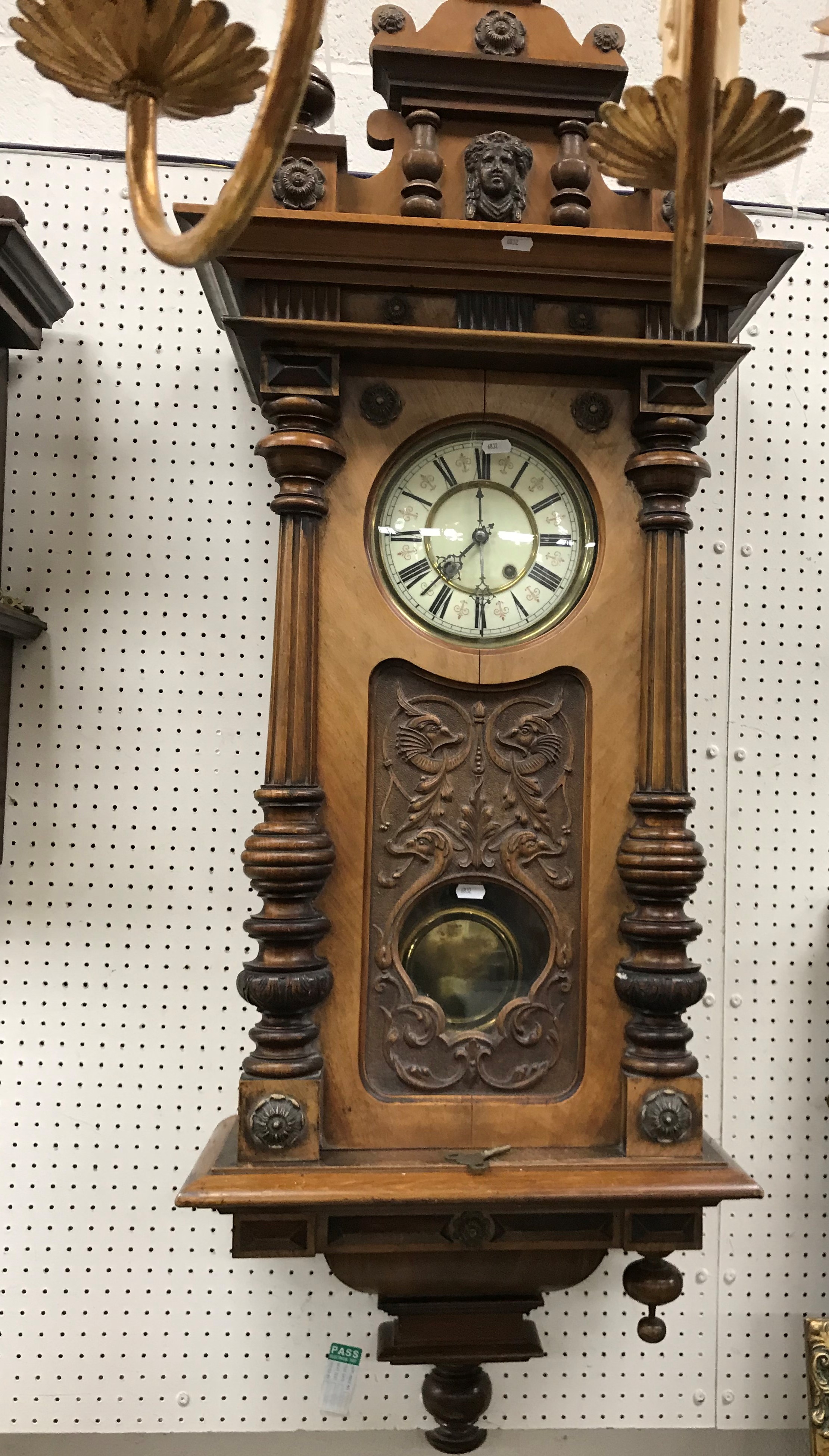 A 19th Century walnut cased Vienna style regulator with carved stylised dolphin decoration in the