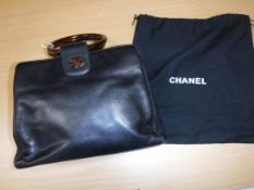 A Chanel black leather handbag with tortoiseshell style hoop handles and CC monogram No'd 5497011