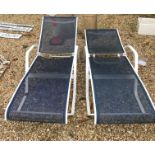 A pair of modern painted metal sun loungers