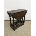 An 18th Century oak oval gate-leg drop-leaf tea table,