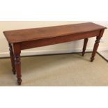 A Victorian mahogany side table, the plain top raised on turned and ringed legs,