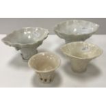 A collection of four Chinese Qing Dynasty 18th/19th Century blanc de chine porcelain libation cups