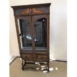 An early 20th Century oak display cabinet in the 17th Century style,