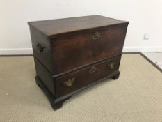 An 18th Century oak mule chest, the plain top opening to reveal a candle box with two drawers,