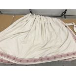 A pair of cotton waffle type curtains in cream with pink gingham and floral banding, interlined,
