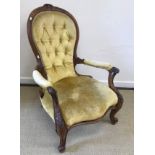 A Victorian spoon back salon armchair with yellow button back upholstery, 100 cm high,