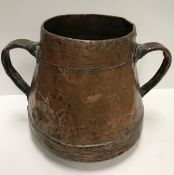 A 19th Century copper two handled water vessel of tapered form with overlaid banding to the top and