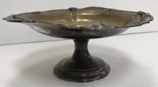 A George V silver tazza with applied shell decoration and rim,