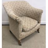 An Edwardian upholstered scroll arm tub chair by Howard & Sons Ltd of London on square tapered