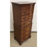 A modern reproduction mahogany serpentine chest on chest of six drawers 53 cm wide x 129 cm high x
