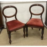 A set of four Victorian mahogany balloon back dining chairs with upholstered drop in seats on