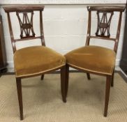 A set of four Edwardian mahogany and inlaid salon chairs with gold upholstered seats on sabre