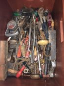 A box of various hand tools including bradle, planes, spanners,