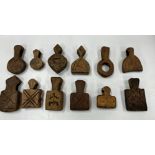 A collection of twelve Islamic carved wooden animal amulets,