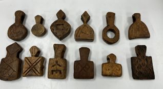 A collection of twelve Islamic carved wooden animal amulets,