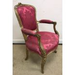 A 19th Century French carved giltwood framed elbow chair in the Louis XV taste raised on moulded