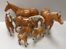 A collection of four Beswick Palomino horse figures together with three Palomino foal figures,