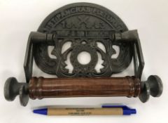 A collection of four modern cast metal toilet roll holders, one inscribed "Great Western Railway",