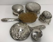 A large silver hinge lidded dressing table box of circular form with engraved swag and bow