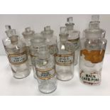 Ten various clear glass pharmaceutical/chemists jars with verre eglomise title panels including