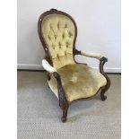 A Victorian spoon back salon armchair with yellow button back upholstery, 100 cm high,