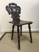 A pair of Victorian oak panel seated hall chairs with pierced medallion backs on baluster turned