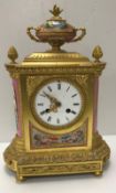 A 19th Century French gilt brassed cased mantle clock with Sèvres style pink ground panels
