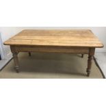 A Victorian farmhouse plank top kitchen table raised on ringed and turned tapering legs (end drawer