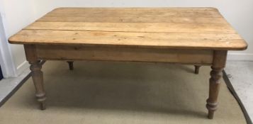 A Victorian farmhouse plank top kitchen table raised on ringed and turned tapering legs (end drawer