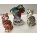 A Royal Doulton figurine "Winter" (HN2088) and two Royal Crown Derby figures of seated cats,