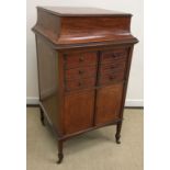 A collection of furniture comprising an Edwardian mahogany and inlaid music cabinet,
