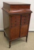 A collection of furniture comprising an Edwardian mahogany and inlaid music cabinet,
