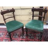 A set of four Victorian bar back dining chairs with green upholstered seats and stud style