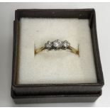 An 18 carat gold three stone diamond dress ring, UK ring size S, 2.