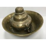 A Middle Eastern Islamic engraved brass deep bowl with central white metal and copper script