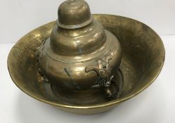 A Middle Eastern Islamic engraved brass deep bowl with central white metal and copper script