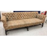 A button upholstered scroll arm sofa in the George III taste raised on square tapering reeded