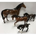 A collection of four Beswick horse figures including large racehorse 36 cm long x 29.