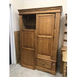 A modern pine wardrobe with two cupboard doors over two drawers on bracket feet 138 cm wide x 56.
