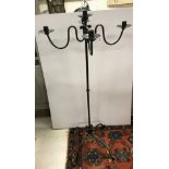 A wrought iron four branch five light candelabra in the 19th Century manner on a plain column to