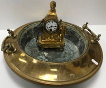 A 19th Century French lacquered brass cased mantle clock with circular enamel dial and Roman
