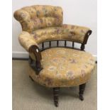 A Victorian stained beech framed upholstered salon tub chair with galleried back on three turned