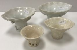 A collection of four Chinese Qing Dynasty 18th/19th Century blanc de chine porcelain libation cups